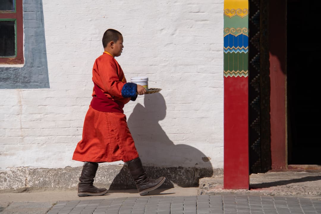 A young monk walks, Mongolia